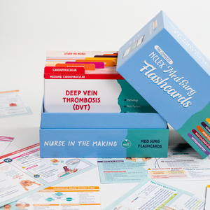 An open box of “NCLEX Med Surg Flashcards” from Nurse in the Making is displayed with flashcards inside, one labeled “Deep Vein Thrombosis (DVT).” The blue box has a tilted lid, revealing neatly organized cards with color-coded tabs. Additional study flashcards are scattered around on a white surface.